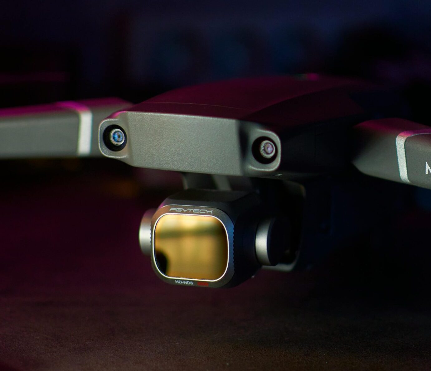 A close-up photo highlighting the Mavic 2 drone's camera and sensor on a dark background.